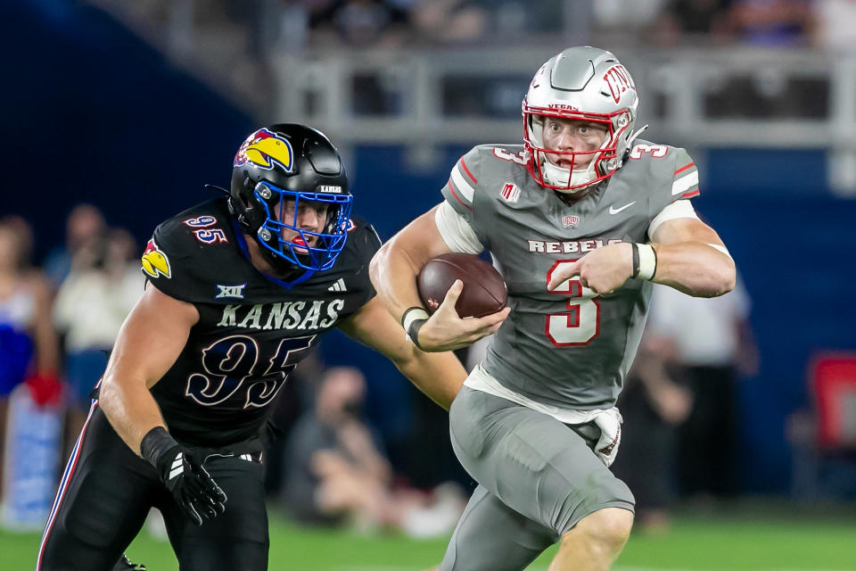 KANSAS CITY, KS - SEPTEMBER 13: UNLV quarterback Matthew Sluka (3) connects with the ball past Kansas defensive end Dylan Wudke (95) during the game between the Kansas Jayhawks and the UNLV Rebels on Friday, September 13, 2024 at Children's Mercy Park yes. Kansas City, Kansas. (Photo by Nick Tre. Smith/Icon Sportswire via Getty Images)